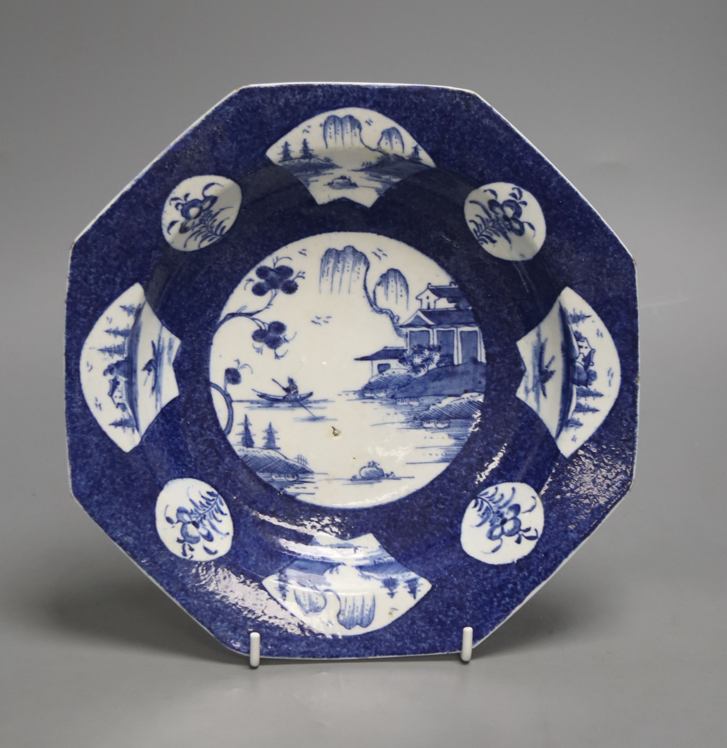 A Bow octagonal plate, painted with landscapes on a blue ground, c.1757, six character mark, 22cm across
